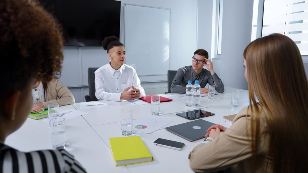 Businesswoman addressing colleague at meeting